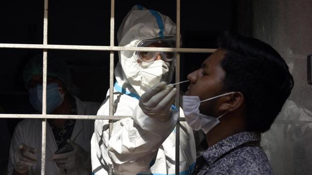 A health worker collects a swab sample from a man to test for Covid-19 infection at SDM office in Amar Colony New Delhi on October 10. As of October 12, there are 8,61,853 total cases of Covid-19, while 61,49,535 people have recovered from the disease. (Sanjeev Verma / HT Photo) A health worker collects a swab sample from a man to test for Covid-19 infection at SDM office in Amar Colony New Delhi on October 10. As of October 12, there are 8,61,853 total cases of Covid-19, while 61,49,535 people have recovered from the disease. (Sanjeev Verma / HT Photo)