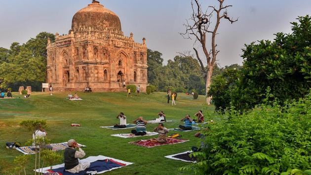 People perform yoga at Lodhi Garden in New Delhi on October 11. As part of a new tree transplantation policy, the Delhi cabinet on October 9 also approved rules making it mandatory for at least 80% of trees affected by any development project to be transplanted, in a move meant to address concerns regarding the city’s green cover. (Biplov Bhuyan / HT Photo)
