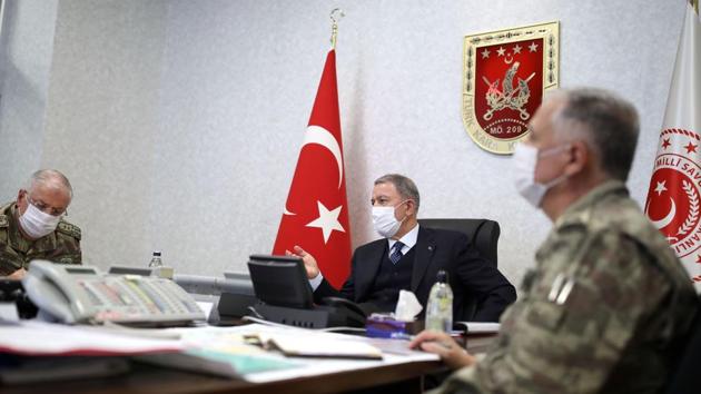 A file handout image made available by the Turkish Ministry of Defense Press Office on June 17, 2020, shows the Turkish Minister of Defense Hulusi Akar (C) and the Turkish Armed Forces Command meeting at the Army Command Control Center in Ankara during the military operation dubbed "Claw-Tiger" on June 17, 2020(AFP)
