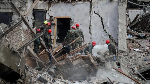 Search and rescue teams work on the blast site hit by a rocket during the fighting over the breakaway region of Nagorno-Karabakh in the city of Ganja, Azerbaijan October 11, 2020.(Reuters photo) Search and rescue teams work on the blast site hit by a rocket during the fighting over the breakaway region of Nagorno-Karabakh in the city of Ganja, Azerbaijan October 11, 2020.(Reuters photo)