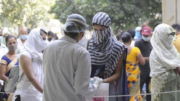 A doctor tends to people at the District Hospital in Sector 30, Noida on October 7. The seven-day average of daily cases in India touched 93,617 on September 16, the highest till date. Since then, however, this number (also referred to as the daily case trajectory) has been dropping steadily and stood at 72,003 on October 10—down around 23% from the peak, HT reported. (Sunil Ghosh / HT Photo) A doctor tends to people at the District Hospital in Sector 30, Noida on October 7. The seven-day average of daily cases in India touched 93,617 on September 16, the highest till date. Since then, however, this number (also referred to as the daily case trajectory) has been dropping steadily and stood at 72,003 on October 10—down around 23% from the peak, HT reported. (Sunil Ghosh / HT Photo)