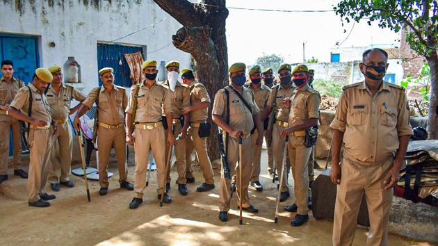 Police personnel stand guard outside the residence of a 19-year-old Dalit woman who died after being allegedly gang-raped, at Bulgadi village in Hathras. (PTI) Police personnel stand guard outside the residence of a 19-year-old Dalit woman who died after being allegedly gang-raped, at Bulgadi village in Hathras. (PTI)