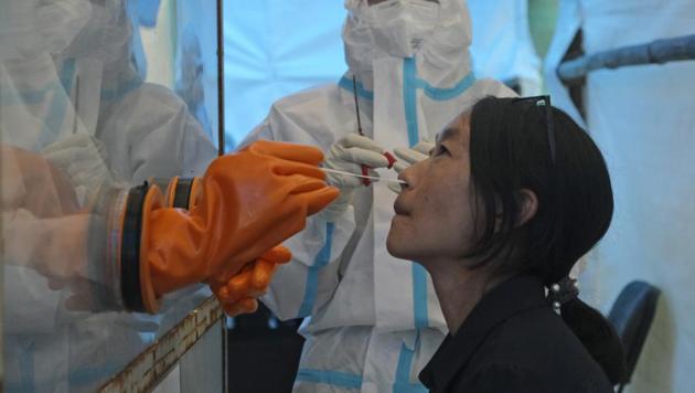 A health worker takes a nasal swab sample to test for Covid-19 in Kohima, capital of the northeastern Indian state of Nagaland, Saturday, Oct. 10, 2020. (AP) A health worker takes a nasal swab sample to test for Covid-19 in Kohima, capital of the northeastern Indian state of Nagaland, Saturday, Oct. 10, 2020. (AP)