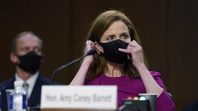 Supreme Court nominee Amy Coney Barrett adjusts her mask and listens during a confirmation hearing before the Senate Judiciary Committee, Monday, Oct. 12, 2020, on Capitol Hill in Washington. (AP) Supreme Court nominee Amy Coney Barrett adjusts her mask and listens during a confirmation hearing before the Senate Judiciary Committee, Monday, Oct. 12, 2020, on Capitol Hill in Washington. (AP)