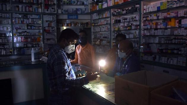 Emergency lights being used at a medical store during a grid failure in Mumbai on October 12. The grid failure was caused by “technical problems” during maintenance work, Maharashtra energy minister Nitin Raut said. In mid 2018, a fire at a transformer sparked similar power cuts in the city and its suburbs. (Bhushan Koyande/ HT Photo)