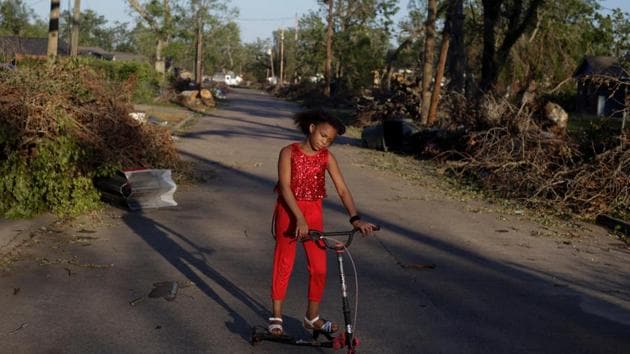 Iyana Sells, 9, plays on her street which is still lined with debris from Hurricane Laura the day after Hurricane Delta swept through Lake Charles in Louisiana on October 10. (Kathleen Flynn / Reuters)