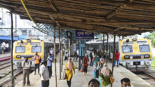Commuters are seen on a platform at a station after local train services were disrupted due to major power outage in Mumbai.(PTI Photo)