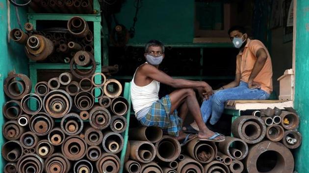 Workers wearing protective face masks sit inside a shop selling iron pipes at a wholesale iron market, after authorities eased lockdown restrictions that were imposed to slow the spread of the coronavirus disease (Covid-19), in Kolkata, India, June 15, 2020. (Reuters photo) Workers wearing protective face masks sit inside a shop selling iron pipes at a wholesale iron market, after authorities eased lockdown restrictions that were imposed to slow the spread of the coronavirus disease (Covid-19), in Kolkata, India, June 15, 2020. (Reuters photo)