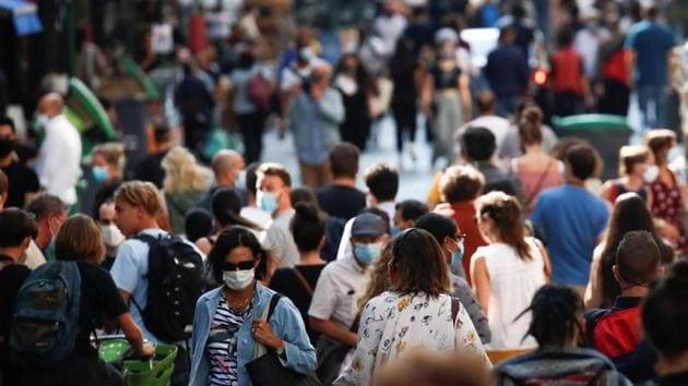 People wearing protective face masks walk in a busy street in Paris as France reinforces mask-wearing in public places as part of efforts to curb a resurgence of Covid-19.(Reuters file photo)
