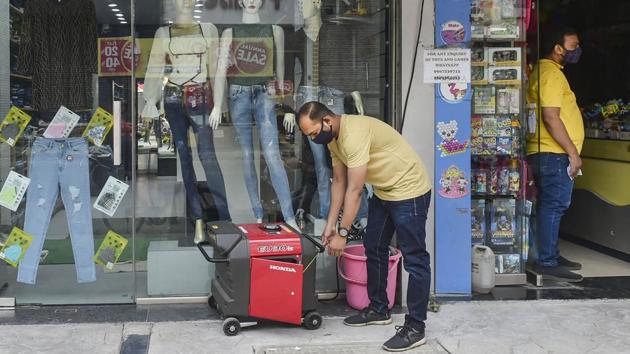 A salesman attempts to start a generator outside his shop after the grid failure in Mumbai on October 12. The power failure in the city led to several schools cancelling their exams while many others cancelled online classes and special events. The Brihanmumbai Municipal Corporation (BMC) directed all hospitals and jumbo Covid-19 facilities to use their power back up to operate ventilators and intensive care units (ICUs) for all patients. (Mitesh Bhuvad / PTI)
