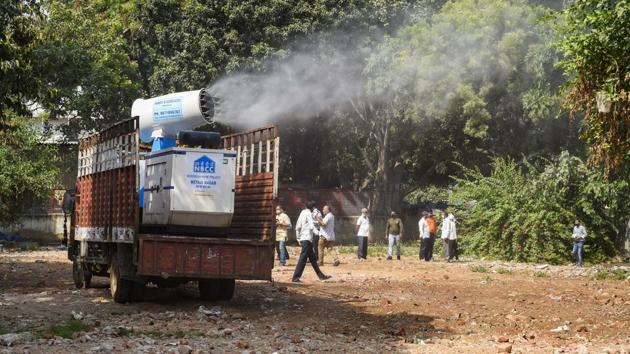 A worker operates an anti-smog gun at a demolition site to control air-pollution, in New Delhi on Sunday. (PTI) A worker operates an anti-smog gun at a demolition site to control air-pollution, in New Delhi on Sunday. (PTI)
