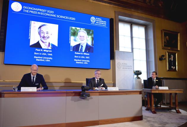 Americans Paul R. Milgrom, left on screen, and Robert B. Wilson have won the Nobel Prize in economics for "improvements to auction theory and inventions of new auction formats."(AP photo)