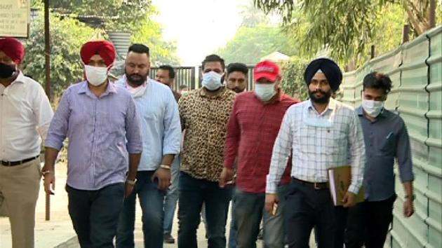 Gangster Baljit Chaudhary (fourth from right), being taken to court in Mohali.