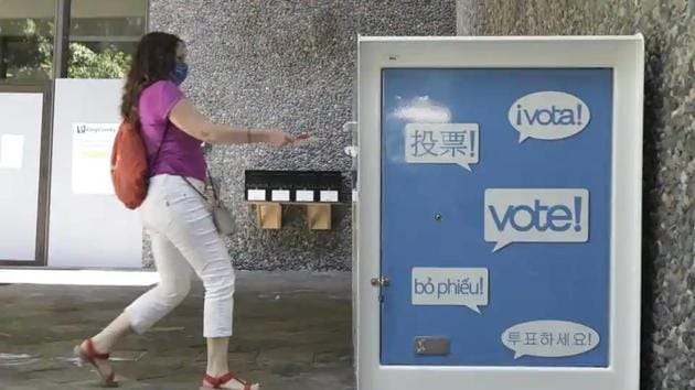 A woman drops off a ballot for Washington state’s primary election at a collection box at the King County Administration Building in Seattle. (AP File Photo) A woman drops off a ballot for Washington state’s primary election at a collection box at the King County Administration Building in Seattle. (AP File Photo)