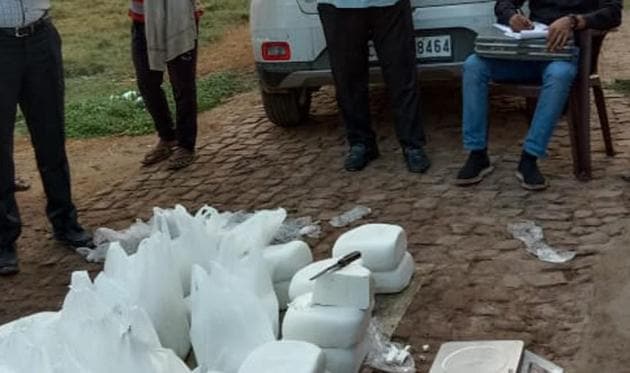 Officials from the food and drugs administration, Panchkula, and the Haryana chief minister’s flying squad examining cottage cheese seized at Barwala in Haryana.(HT Photo)