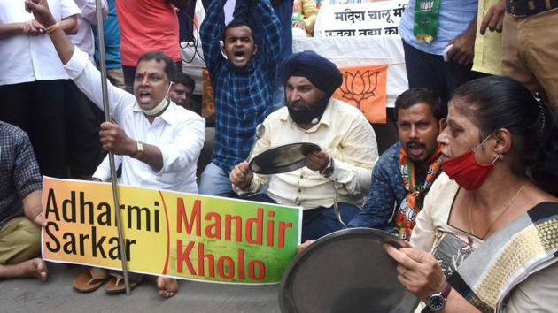 BJP workers stage a protest as part of their statewide rotational hunger strike demanding opening up of temples, outside Siddhivinayak Temple in Mumbai on Tuesday.(PTI)