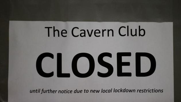A public notice hangs outside The Cavern Club in Liverpool on October 12. Areas under the “very high” risk category will face restrictions including closing pubs—apart from those that serve meals. (Phil Noble / REUTERS)