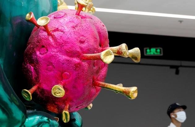 The sculpture can be considered as a firm stand against the bleak reality we are currently living in, with its shinny magenta and gold depiction of the coronavirus and the peacock green colour coating on the Genie. (REUTERS)