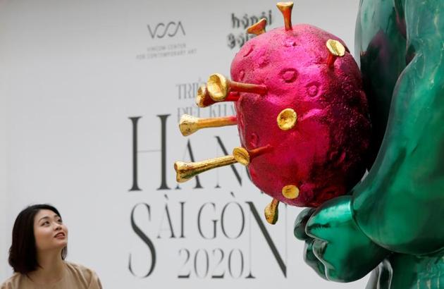 The sculpture, titled the “Land Genie” holds a caricature of the SARS CoV virus, in all of its crowned glory. (REUTERS)