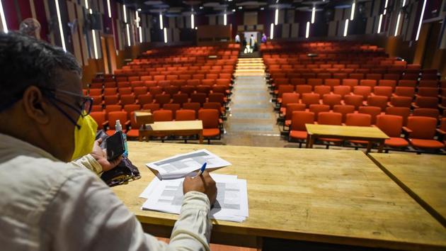 A faculty member makes arrangements to address students arriving with queries during the admission process for the academic year 2020-21, at Ramjas College in New Delhi on October 12. Admission season has begun at Delhi University (DU) but amid the ‘new normal’ triggered by the Covid-19 pandemic and without the usual campus buzz. (Amal KS / HT Photo)
