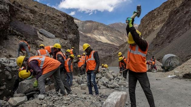 Labourers from the Border Roads Organisation (BRO) work on a highway under construction in the Ladakh region.(Reuters file)