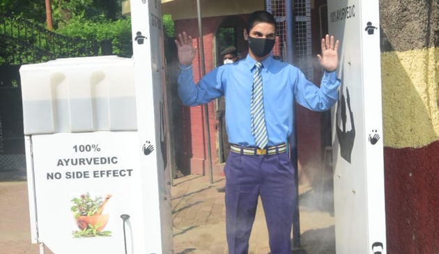 A school student passes through a sanitisation tunnel put up at St Joseph’s College in Prayagraj. (HT) A school student passes through a sanitisation tunnel put up at St Joseph’s College in Prayagraj. (HT)