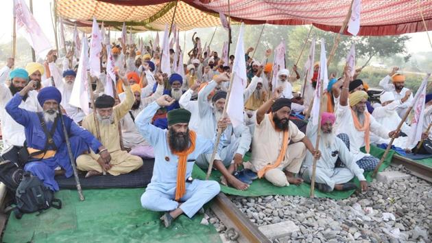 Punjab farmers protesting on a rail track near Amritsar. The farm union activists have laid siege to key rail routes in Punjab since September 24, impacting the supply of the essential services such as coal for the state’s thermal power generation units, the movement of foodgrains to consumer states from Punjab’s godowns, and the supply of fertilisers such as di-ammonium phosphate and urea needed for sowing Rabi crops. (Sameer Sehgal/HT) Punjab farmers protesting on a rail track near Amritsar. The farm union activists have laid siege to key rail routes in Punjab since September 24, impacting the supply of the essential services such as coal for the state’s thermal power generation units, the movement of foodgrains to consumer states from Punjab’s godowns, and the supply of fertilisers such as di-ammonium phosphate and urea needed for sowing Rabi crops. (Sameer Sehgal/HT)
