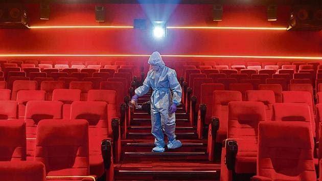 A worker sanities inside a theatre hall ahead of the scheduled reopening of cinema theatres on October 15 as the Covid-19 coronavirus imposed lockdown eases further in Mumbai on October 13, 2020. (AFP) A worker sanities inside a theatre hall ahead of the scheduled reopening of cinema theatres on October 15 as the Covid-19 coronavirus imposed lockdown eases further in Mumbai on October 13, 2020. (AFP)