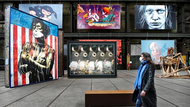 A woman looks at street art displayed at the International Street Art Museum in Amsterdam, Netherlands on October 14. The Netherlands have imposed a partial lockdown to curb one of the region’s worst coronavirus surges, with all bars, cafes and restaurants to close, and non-medical face coverings mandatory in all indoor spaces for people aged over 13. (Piroschka van de Wouw / REUTERS)