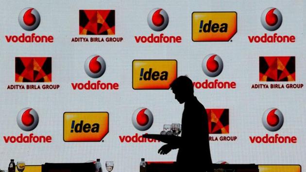 A hotel employee clears a table after Vodafone Group and Idea Cellular news conference in Mumbai. (REUTERS) A hotel employee clears a table after Vodafone Group and Idea Cellular news conference in Mumbai. (REUTERS)