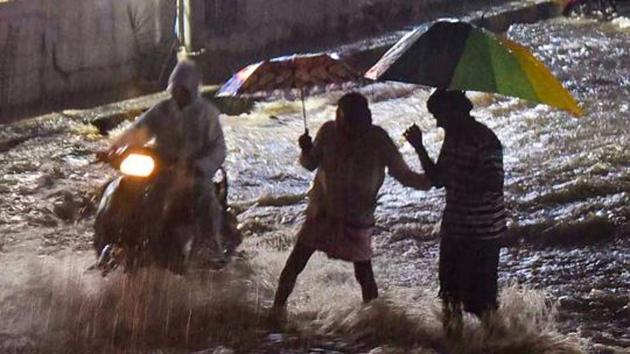Hyderabad: Motorcyclists wade through flooded Mahboob Mansion market road following heavy rains, in Hyderabad, Tuesday (PTI) Hyderabad: Motorcyclists wade through flooded Mahboob Mansion market road following heavy rains, in Hyderabad, Tuesday (PTI)