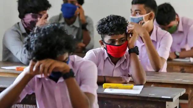 Students wearing protective masks wait for vocational higher secondary education exams which were postponed amid the coronavirus disease (Covid-19) spread, inside a school in Kochi. (Reuters File Photo) Students wearing protective masks wait for vocational higher secondary education exams which were postponed amid the coronavirus disease (Covid-19) spread, inside a school in Kochi. (Reuters File Photo)