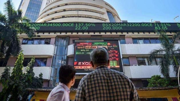 People watch the Sensex on a screen outside Bombay Stock Exchange (BSE) in Mumbai.(PTI File Photo)