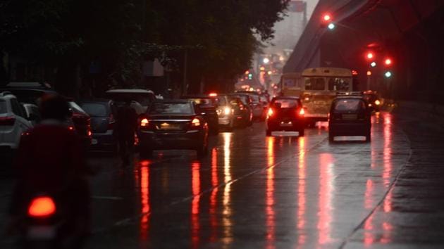Reflection of lights on road as it rained in Dadar in Mumbai, India, on Wednesday.(Satish Bate/HT Photo)