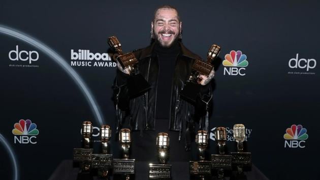 Post Malone poses with awards at the 2020 Billboard Music Awards broadcast on October 14, 2020 at the Dolby Theatre in Los Angeles.(Via REUTERS)