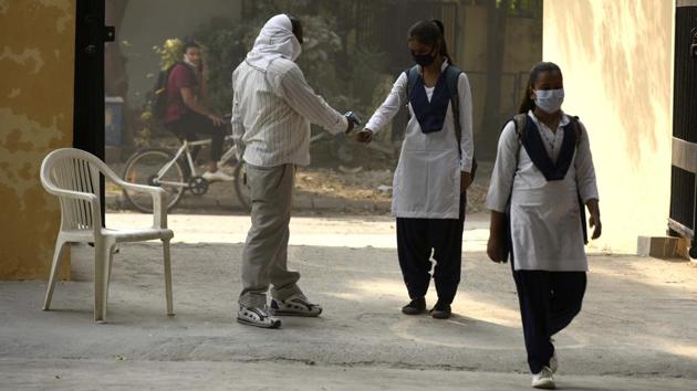 Students are thermal screened before entering a school in Gurugram on October 15. The latest activities to be “unlocked” pose some of the biggest infection risks: the virus can spread easily in closed spaces such as cinema halls, quickly among crowds typical at religious festivals, and potentially unchecked in children who can then pass it on to more vulnerable people at home. (Parveen Kumar / HT Photo)