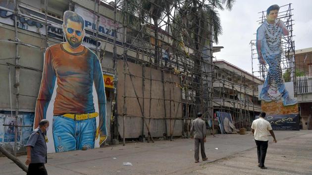 People walk through the premises of a cinema theatre in Bangalore on October 15.The films may be old, masks mandatory and the usual lavish menus absent, but cinema-owners hope moviegoers will still flock back after a nearly seven-month coronavirus shutdown. (Manjunath Kiran / AFP)