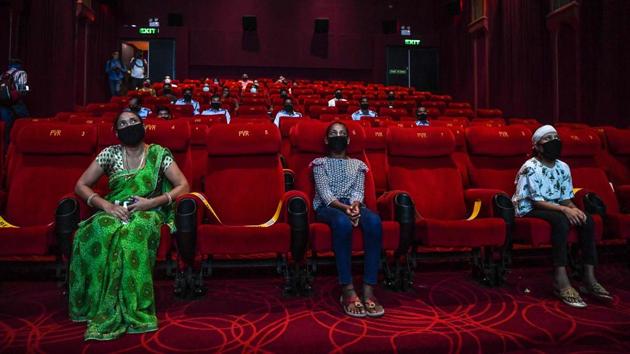 Families of frontline Covid-19 workers watch a movie during a special screening in New Delhi on October 15. Crediting government strategies and Covid-19 warriors with the improvement in India’s case doubling time, the ministry further tweeted, “This is the result of the Centre-led strategies and the selfless dedication of doctors, paramedics, frontline workers and all other Covid-19 warriors.” (Prakash Singh / AFP)