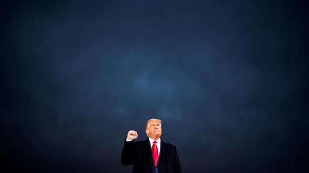 US President Donald Trump makes a fist during a campaign rally at Des Moines International Airport in Des Moines, Iowa (REUTERS/Carlos Barria)