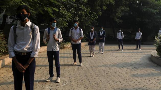 Students maintain social distance and stand in a line at a government-run school in Gurugram on October 15. At a meeting with central government hospitals on October 14, Union health minister Harsh Vardhan said “The next two-and-a-half months are going to be very crucial for us in our fight against corona because of the winter season and the festival season.” (Anushree Fadnavis / REUTERS)
