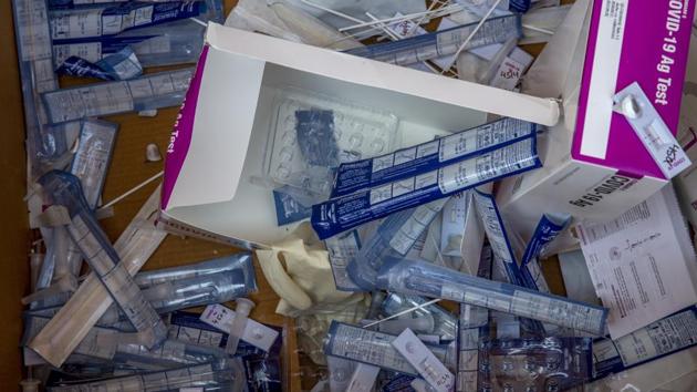 Discarded nasal swab samples and rapid test kits lie inside a box after testing for Covid-19 in Srinagar on October 14. After weeks of recording more than 80,000 and 90,000 cases a day, India’s rise in new cases per day has seen a dramatic fall in recent days. The country’s last spike was 63,509 on October 14. (Dar Yasin / AP)