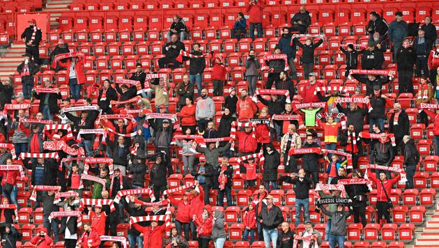 Supporters of German first division Bundesliga 1 FC Union Berlin cheer for their team on the stands during a friendly test football match between 1 FC Union Berlin and second division club Hannover 96 in Berlin on October 8, 2020. (Photo by Tobias Schwarz / AFP) / DFL REGULATIONS PROHIBIT ANY USE OF PHOTOGRAPHS AS IMAGE SEQUENCES AND/OR QUASI-VIDEO(AFP)