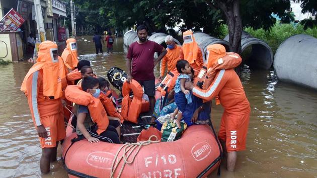 National disaster response force (NDRF) rescuing families near Hyderabad on Thursday.(ANI)