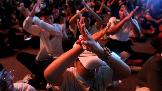 People gesture during anti-government protest in Bangkok on October 15. Student-led pro democracy protests that started in August appear to be at its peak - after more than 10,000 people attended the protest at Bangkok intersection on October 15. Braving a possibility of being detained by the state apparatus at length without charge, people defied state emergency to participate in the protest. (Soe Zeya Tun / Reuters)