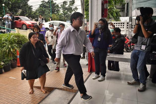 Pro-democracy activist Bunkueanun "Francis" Paothong enters the Dusit Police Station to answer charges of harming Thailand's Queen Suthida, two days after protesters nearly obstructed a royal motorcade, in Bangkok on October 16, 2020. (Photo by Lillian SUWANRUMPHA / AFP) (AFP) Pro-democracy activist Bunkueanun "Francis" Paothong enters the Dusit Police Station to answer charges of harming Thailand's Queen Suthida, two days after protesters nearly obstructed a royal motorcade, in Bangkok on October 16, 2020. (Photo by Lillian SUWANRUMPHA / AFP) (AFP)