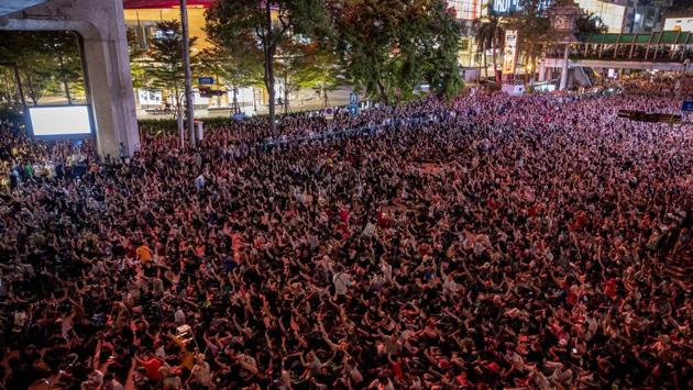 Pro-democracy protesters occupy a road in the central business district in Bangkok on October 15. According to AP’s report, some 10,000 protesters defied the emergency on October 15 to rally at the Bangkok intersection. (Gemunu Amarasinghe / AP)
