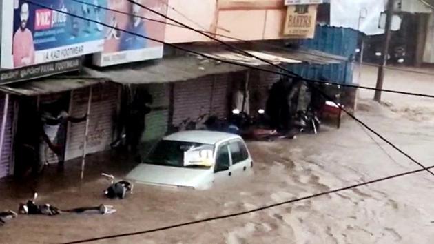Vehicles sink in floodwater at Hukkeri town as heavy rainfall reported in several parts of the Karnataka. (ANI photo) Vehicles sink in floodwater at Hukkeri town as heavy rainfall reported in several parts of the Karnataka. (ANI photo)