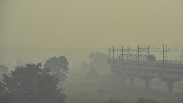 A metro train can be seen through a haze in New Delhi on Thursday. (PTI) A metro train can be seen through a haze in New Delhi on Thursday. (PTI)