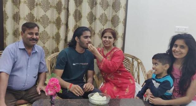 Ujjwal Choudhary celebrating with his family members at home after securing AIR 647.(HT)