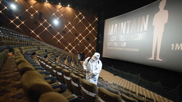 A worker chemically disinfects an auditorium at Miraj Maximum Cinema, in Gurugram on October 14. A number of states across the country have shown a dip in the number of Covid-19 cases as the economy moved towards further unlocking this week --Haryana, Mizoram, Nagaland, Goa and Sikkim among them. (Parveen Kumar / HT Photo)